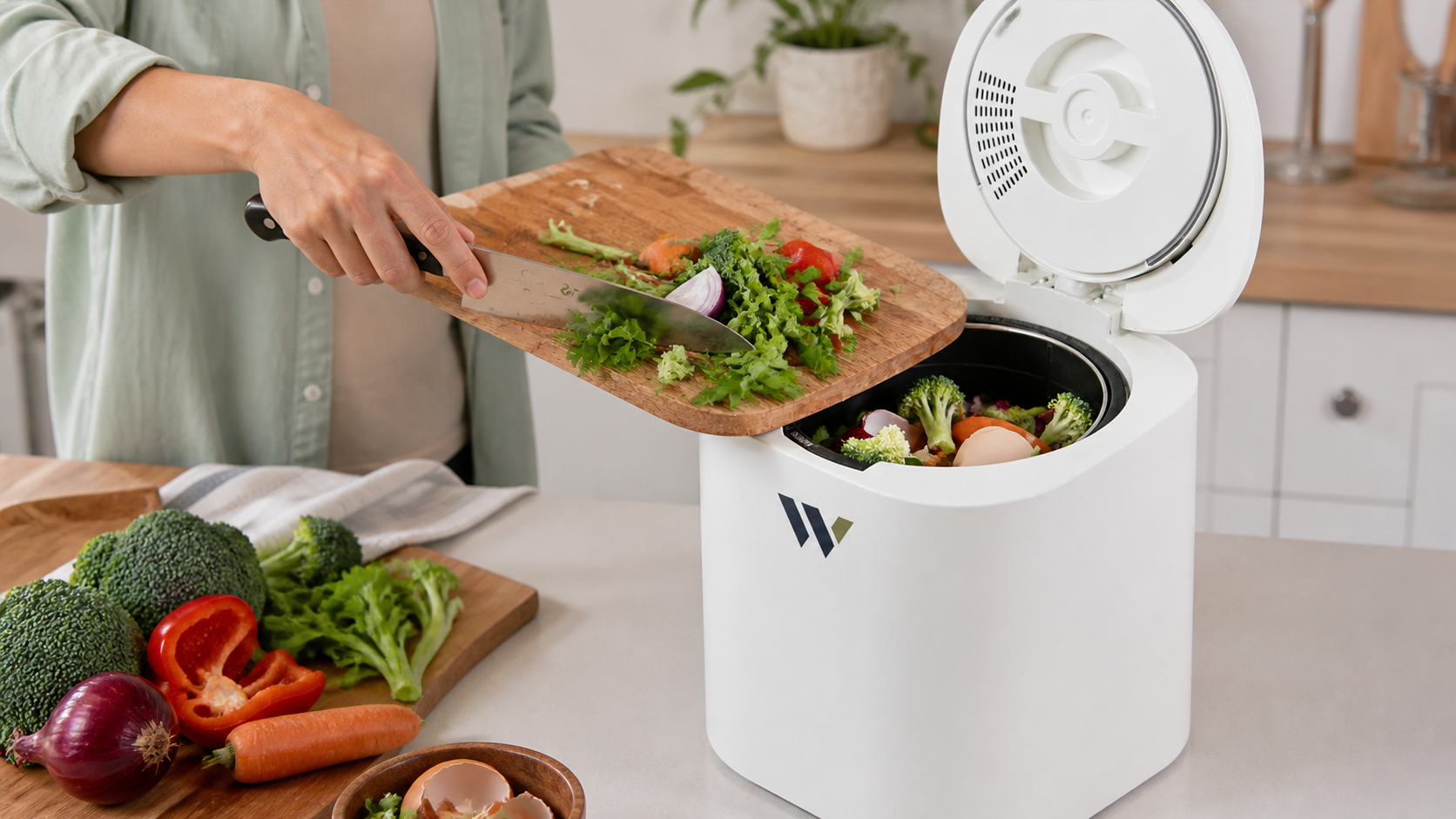 Vegetable preparation scraps being transferred into an open Wawli Element 1 household composter