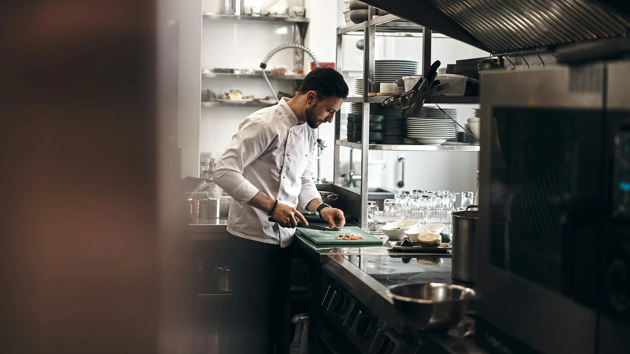 Chef preparing food in a professional commercial kitchen