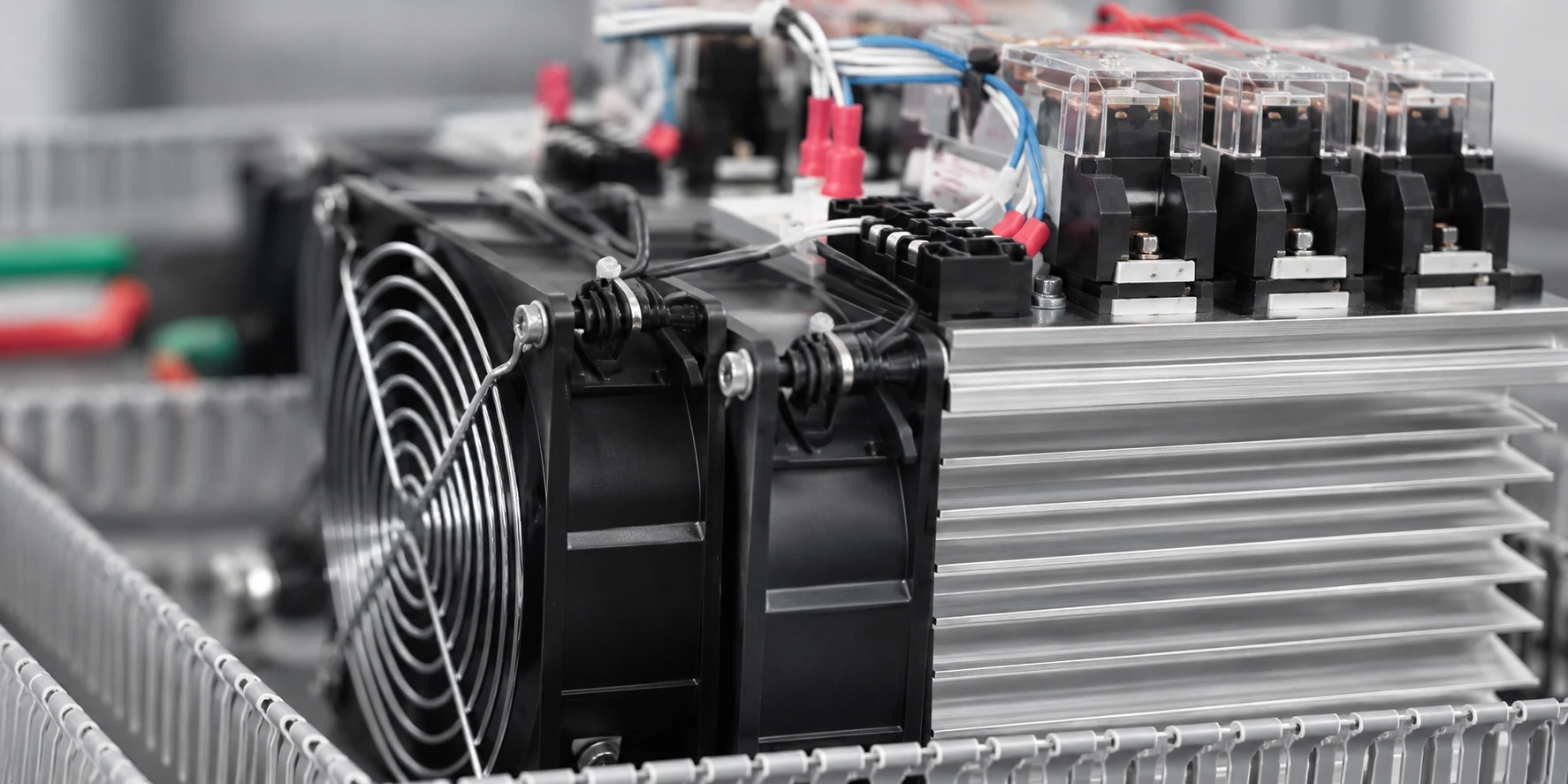 Close-up of electrical control components, cooling fan, wiring and an aluminium heatsink